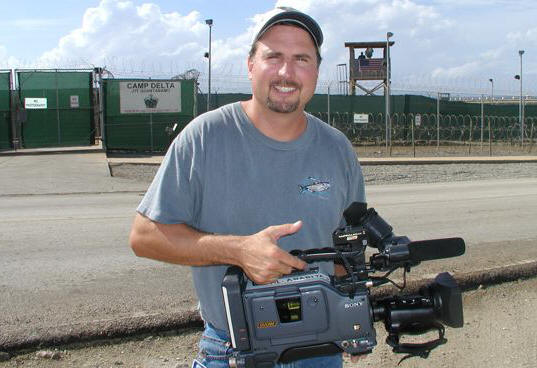 freelance videographer holds video production camera